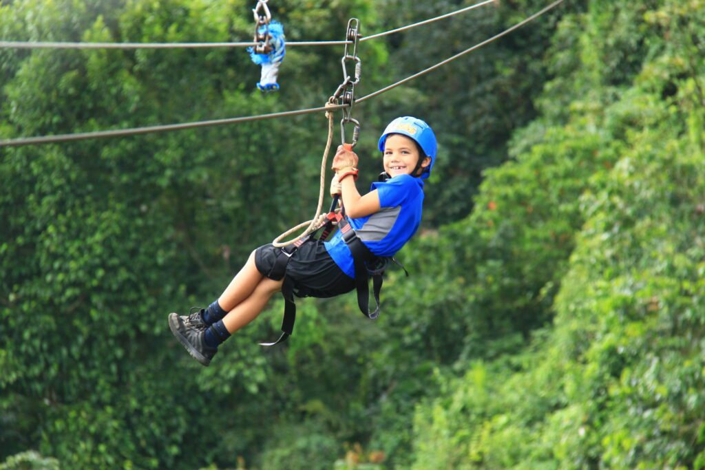 Boy Ziplining over the canopy in Costa Rica 