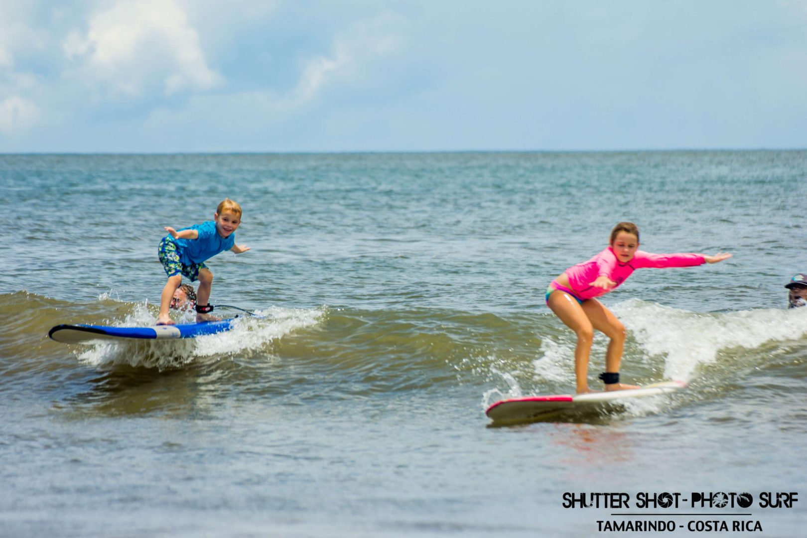 Two kids surfing the waves in Costa Rica 