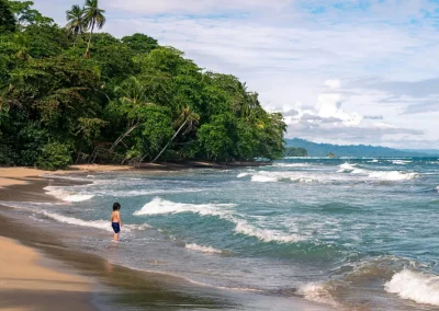 Children playing at a calm beach with gentle waves in Costa Rica