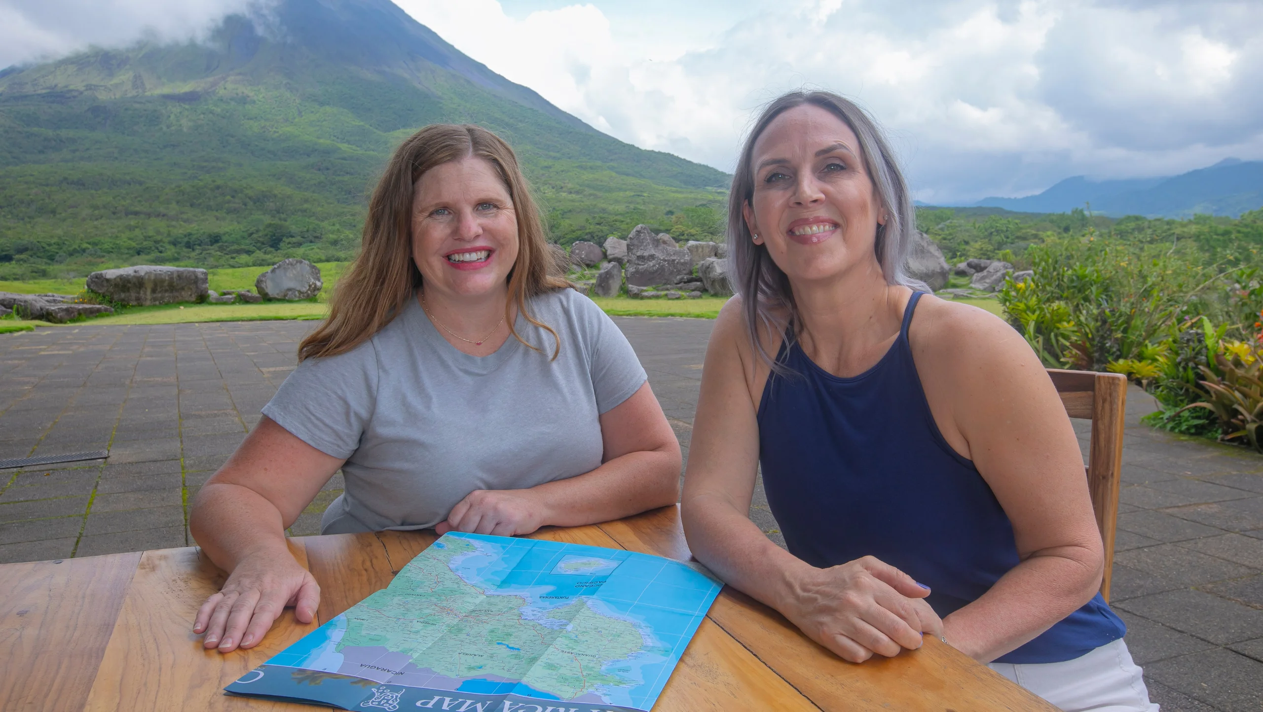 Christa and Vanessa planning a family trip to Costa Rica near Arenal Volcano