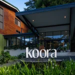 Front entrance of Koora Hotel surrounded by lush greenery in Monteverde, Costa Rica.